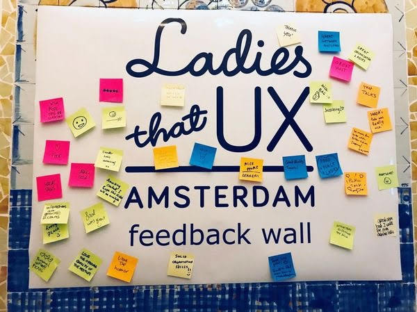 Ladies that UX Amsterdam feedback wall covered with community notes